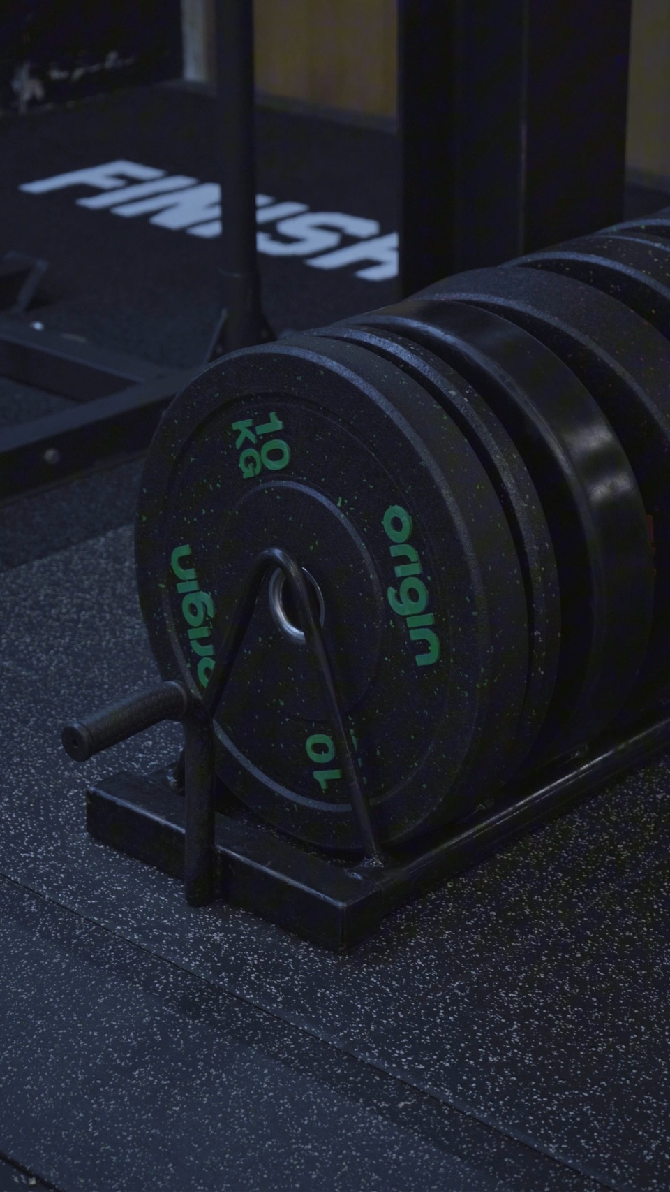Rubber weight plates racked on the gym floor
