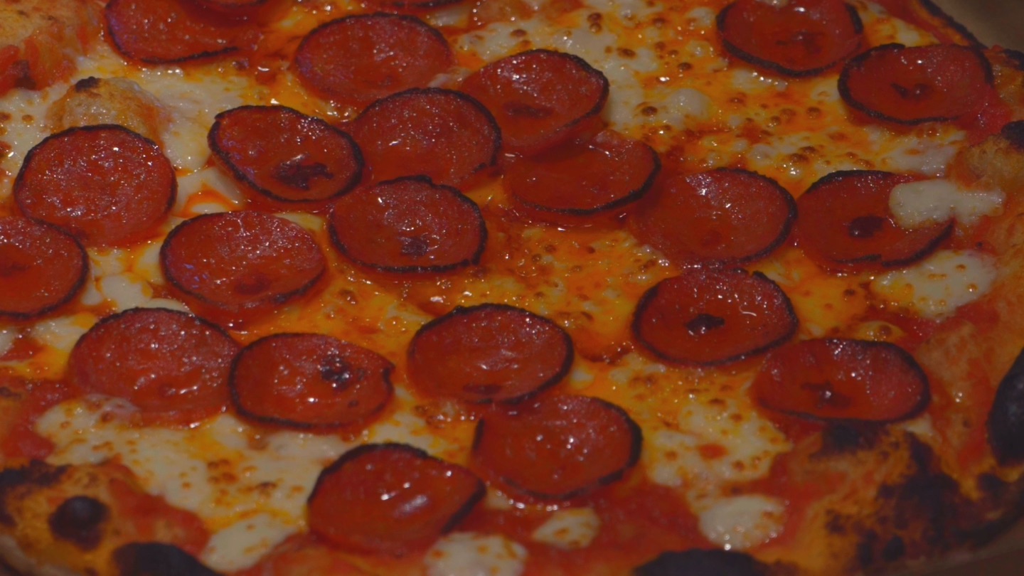 A pepperoni pizza straight from the oven, in its box